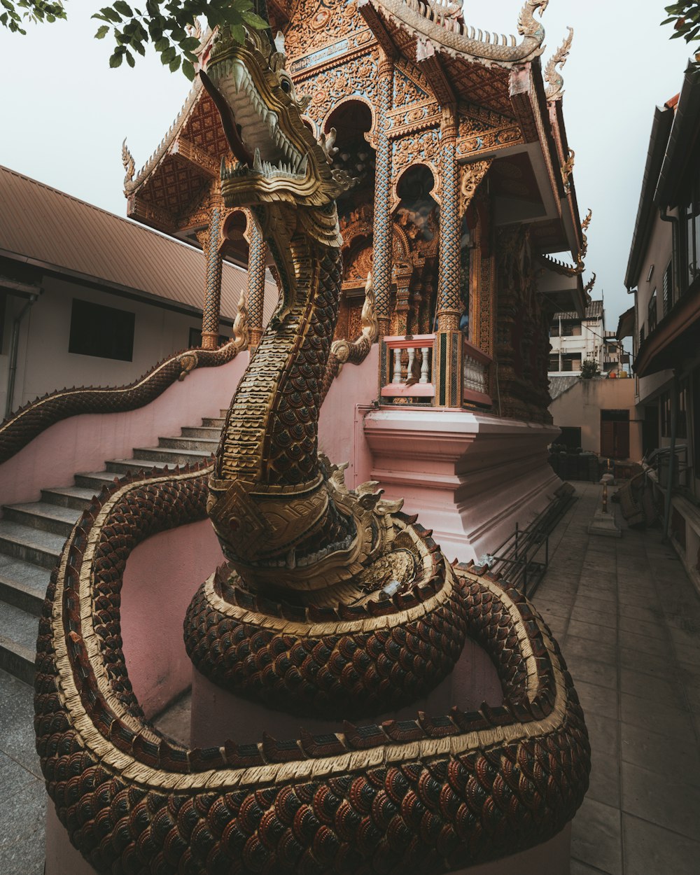 gold dragon statue on top of building