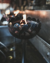 Close-up of a traditional lamp lit during evening prayers inside the temple.