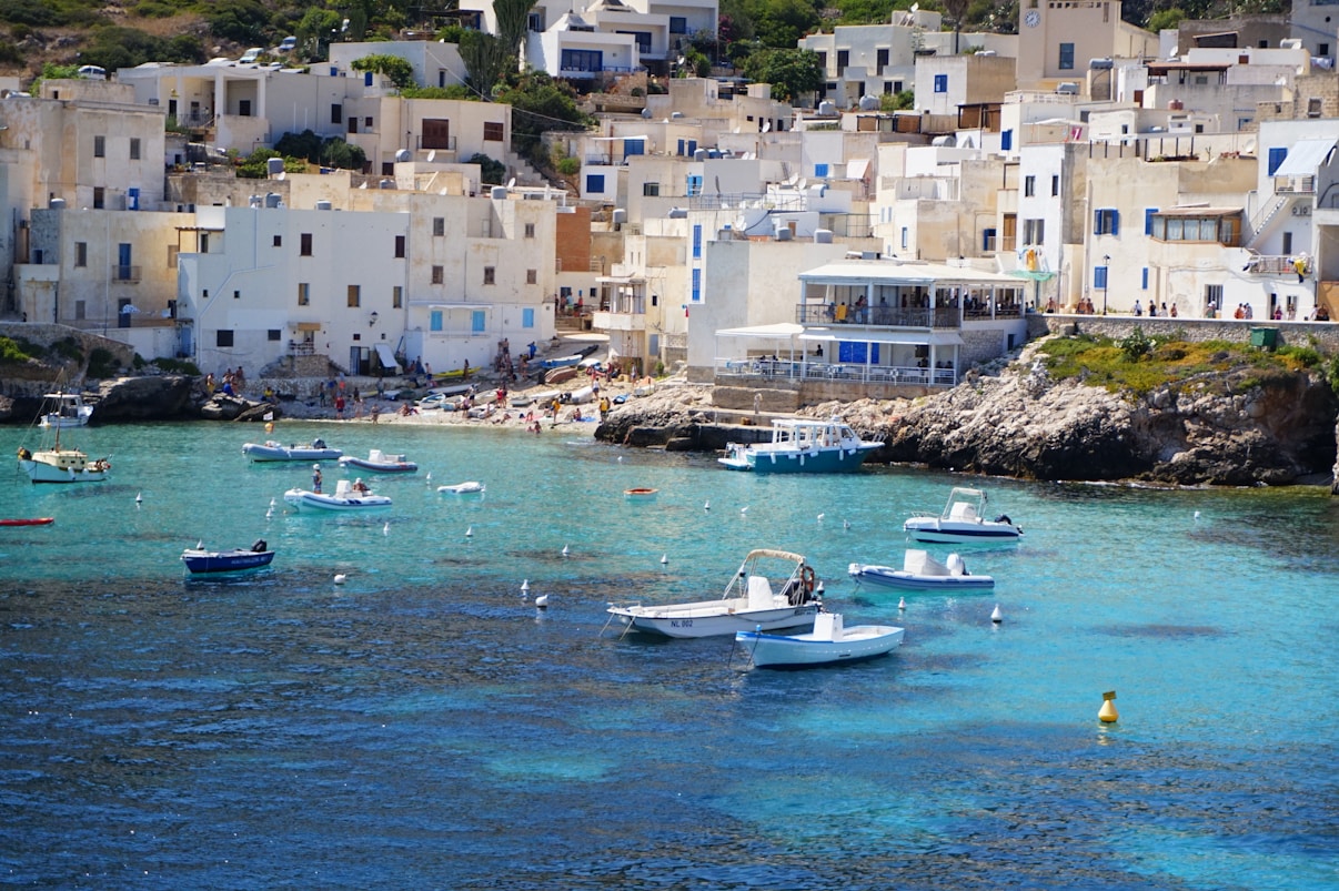 white and blue boat on sea during daytime
