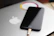 A happy customer holding a sleek black iPhone charger from nexovivo in a bright, modern room.