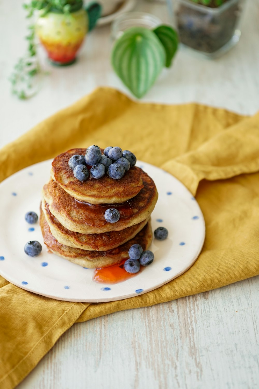 pain brun aux baies bleues sur assiette en céramique blanche