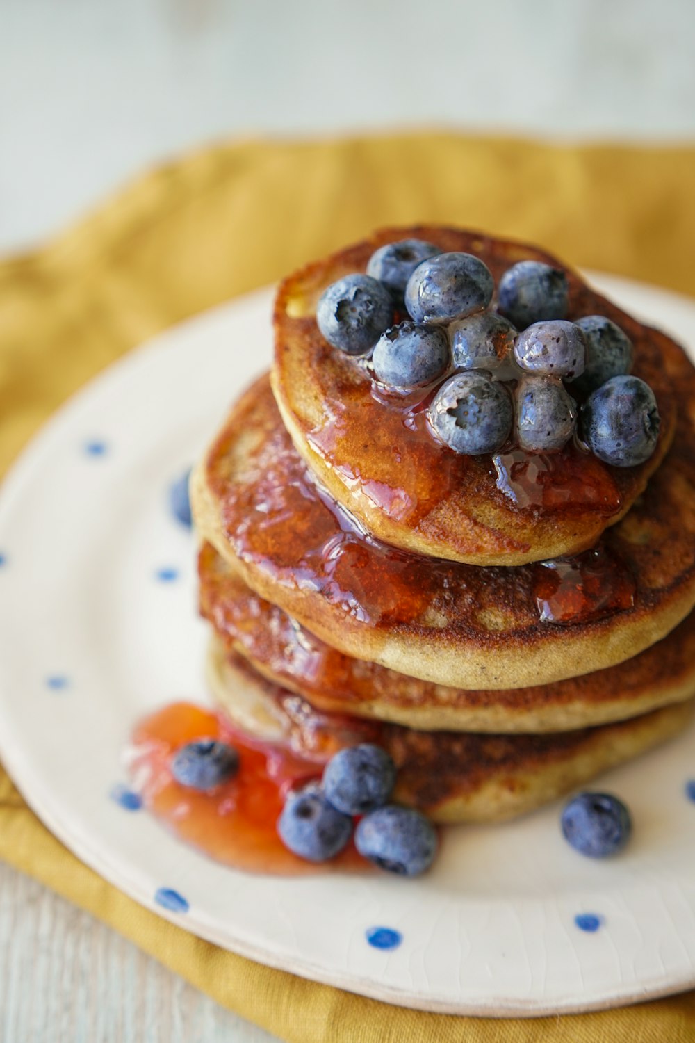 pancakes with blue berries on white ceramic plate