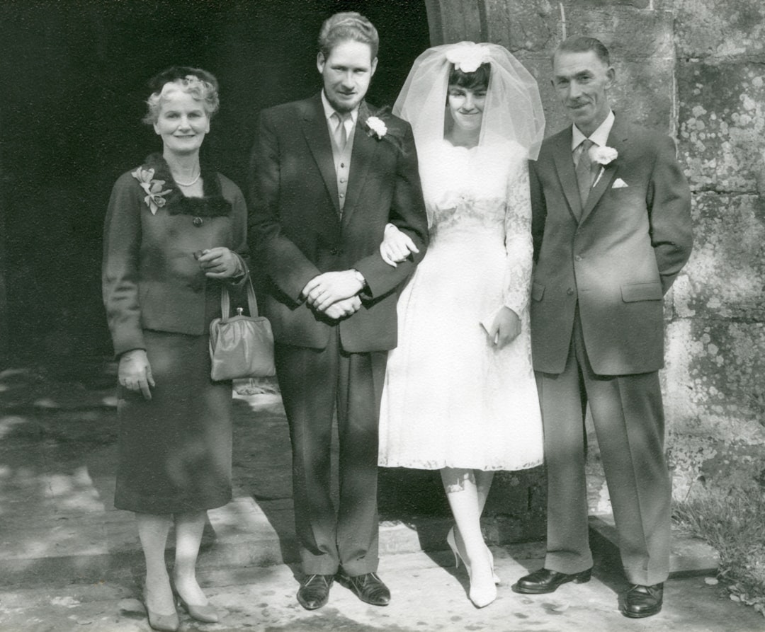 grayscale photo of man and woman in formal suit