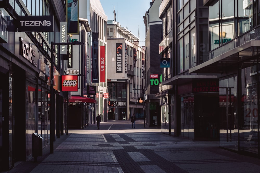 people walking on sidewalk near buildings during daytime