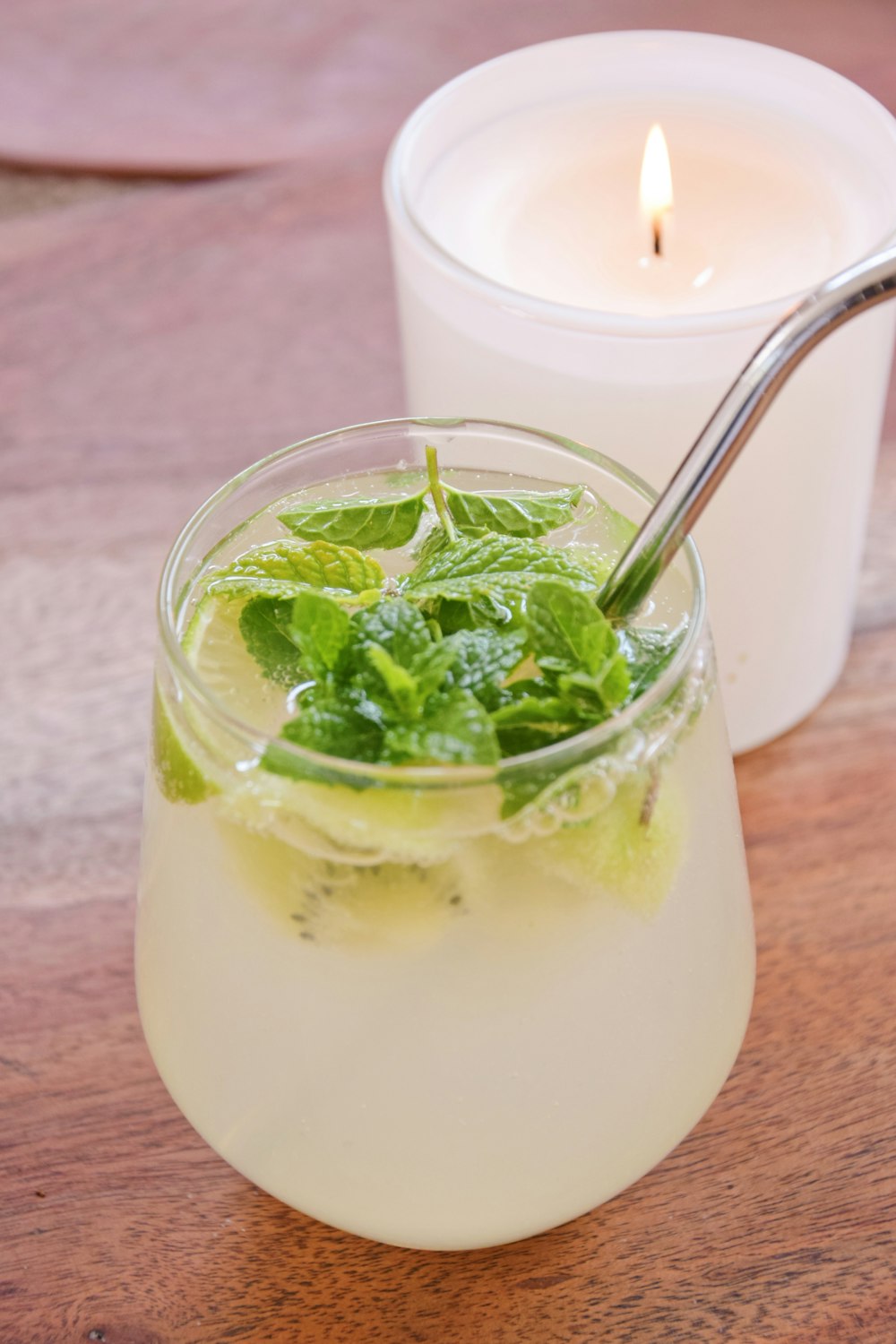 clear drinking glass with white liquid and green leaves