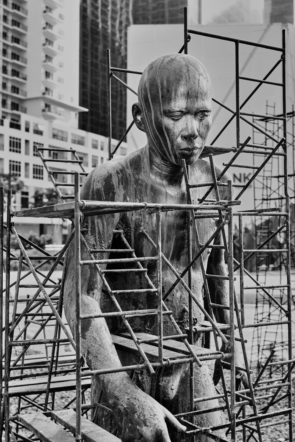 man in black leather jacket standing near fence