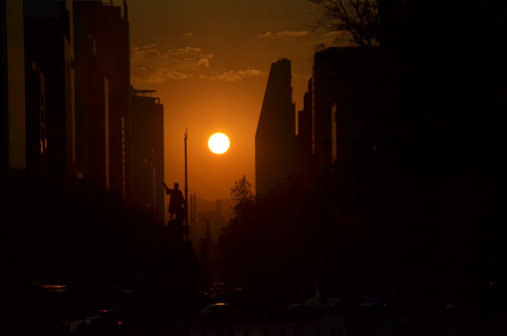 silhouette of city buildings during sunset