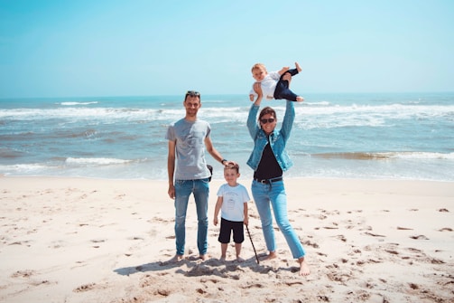 A happy family enjoying a sunny beach day together.