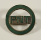 a green and gold pin with the word pint on it