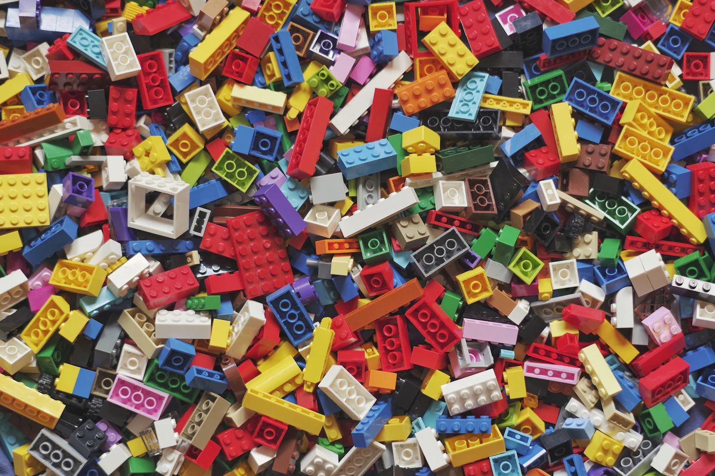 Colorful interlocking plastic bricks spread on a bright surface