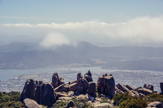 brown rocky mountain near body of water during daytime in Mount Wellington Australia