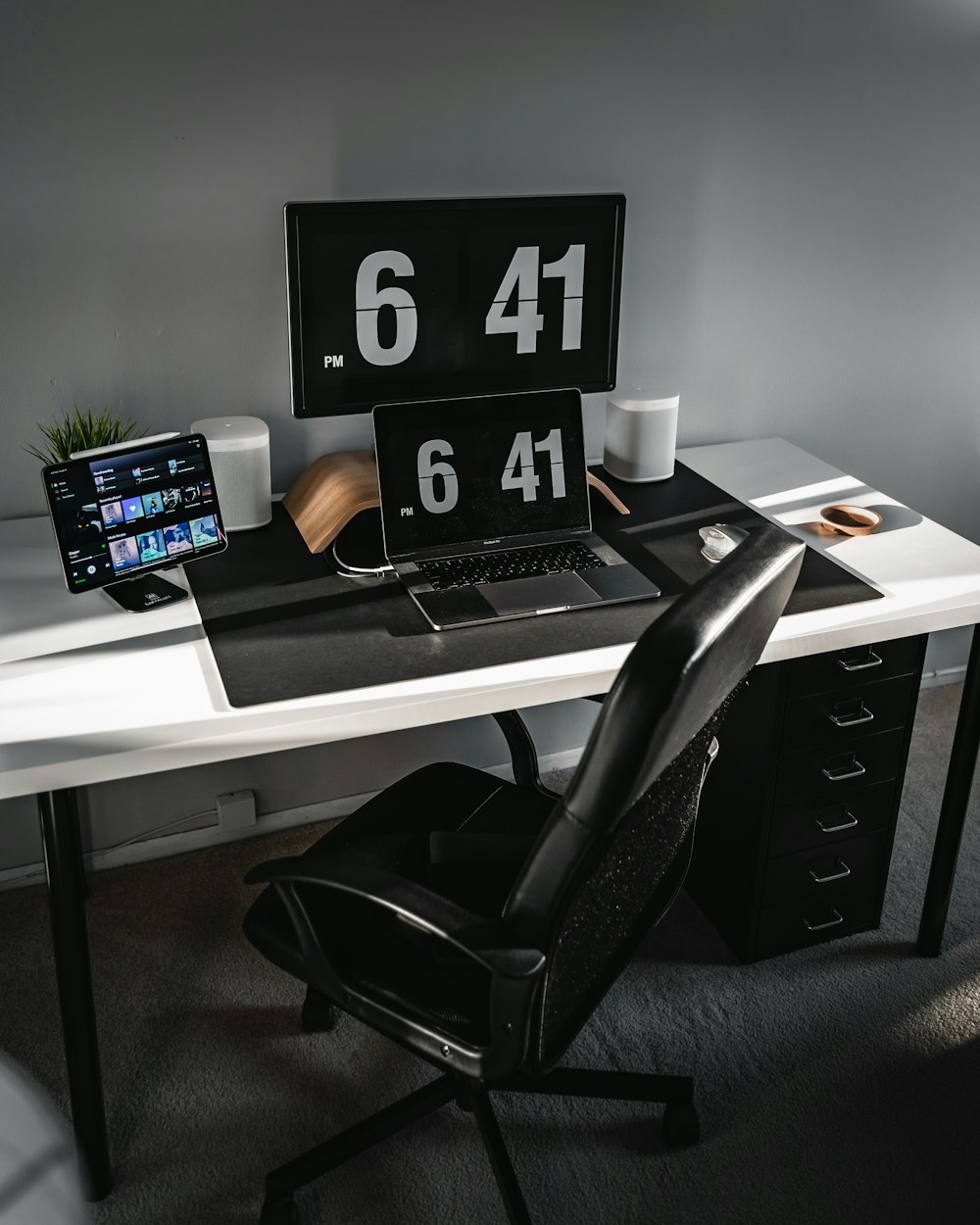 black and white wooden desk with black laptop computer
