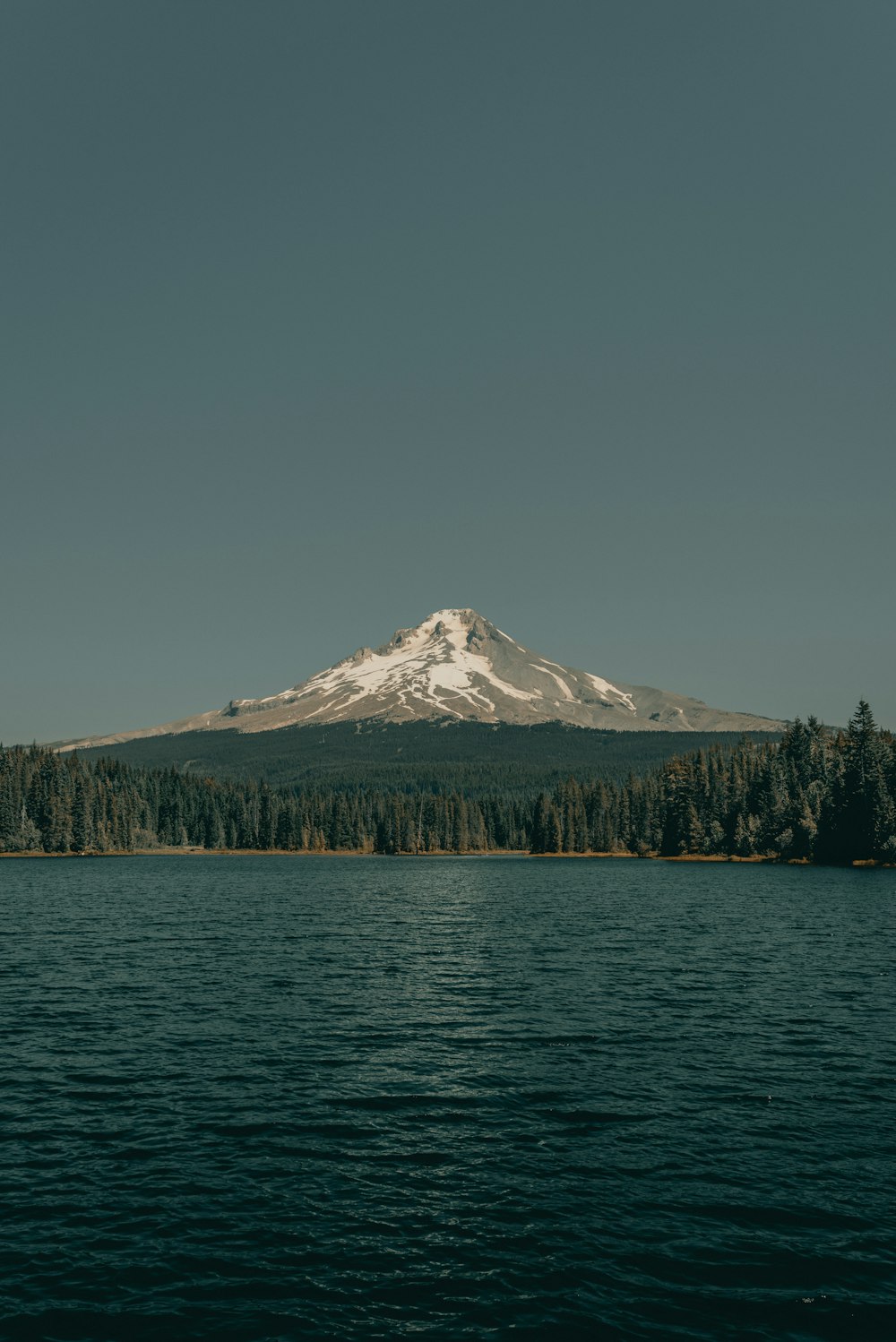 a large body of water with a mountain in the background