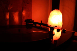A cozy living room scene with a record player spinning vinyl and warm lighting.