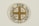 A circular pin badge with a gold cross dividing the letters 'C', 'L', 'W', 'S' in each quadrant. Surrounding the cross, the words 'Justice For Women' are printed in bold black text. The badge background is predominantly white, with a subtle decorative element at the bottom.