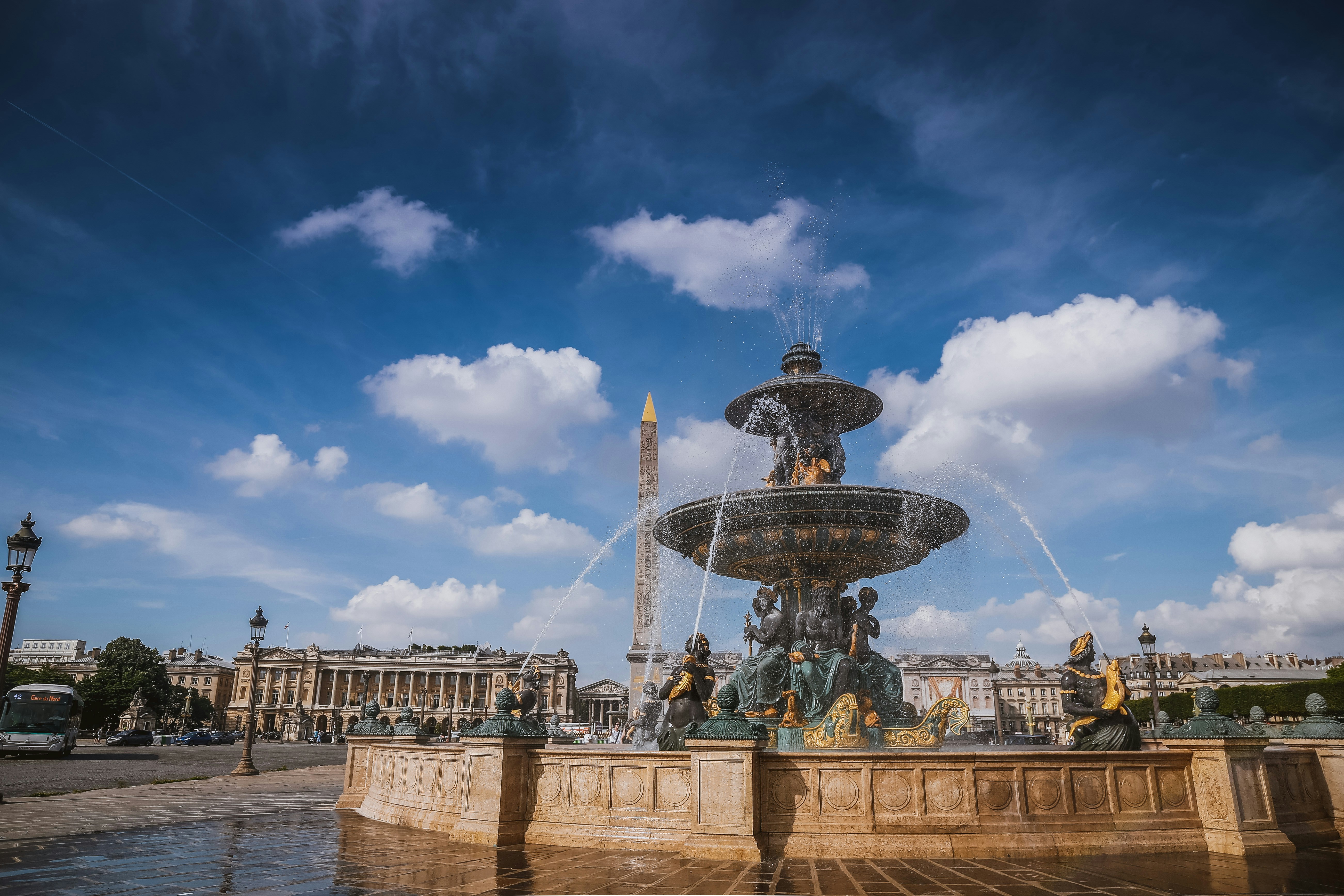 water fountain under blue sky and white clouds during daytime, Place de la Concorde 