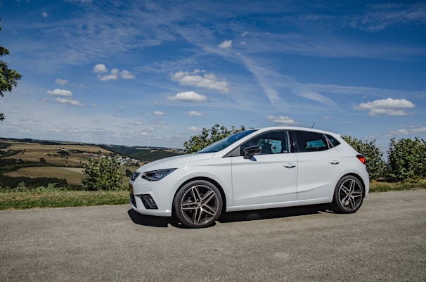 A comfortable car parked beside a scenic road in Bilaspur, ready for a journey.