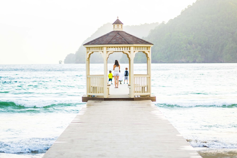 brown wooden gazebo on beach during daytime