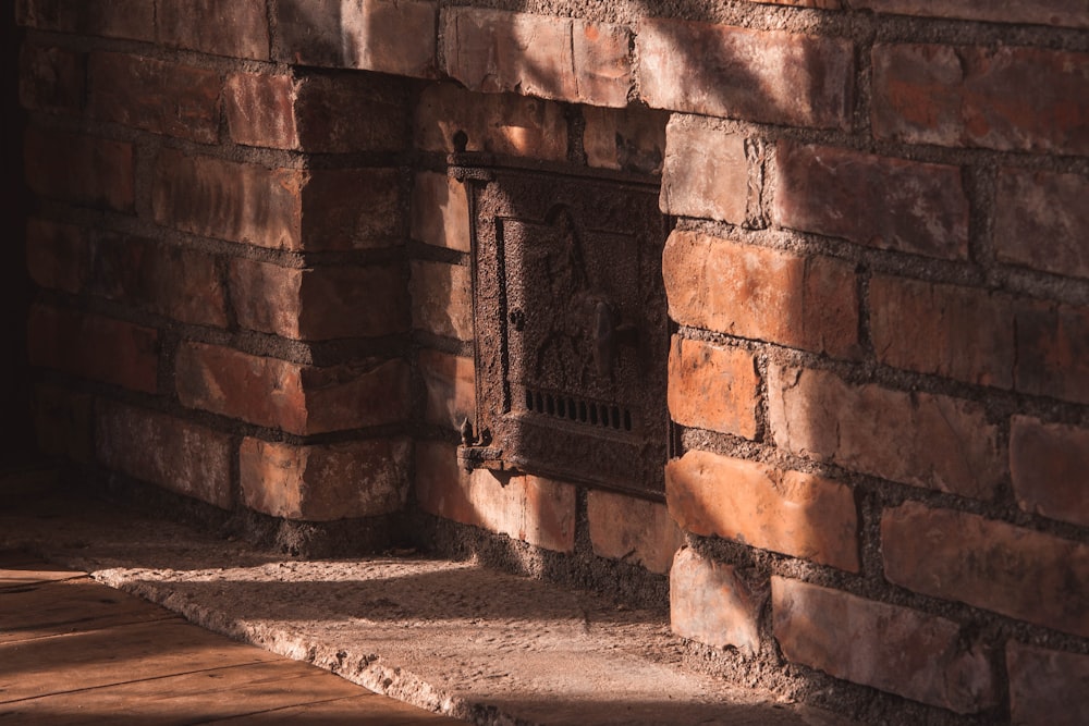 brown brick wall with black metal door