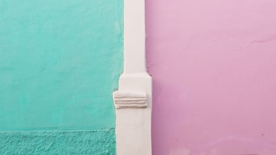 white leather strap on green wall