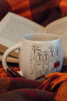 Custom gift set with matching coffee mug and tumbler, both adorned with whimsical hand-drawn animals and vibrant splashes of color.