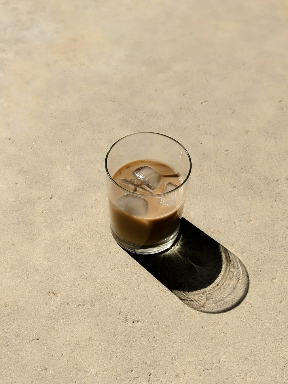 clear drinking glass with brown liquid