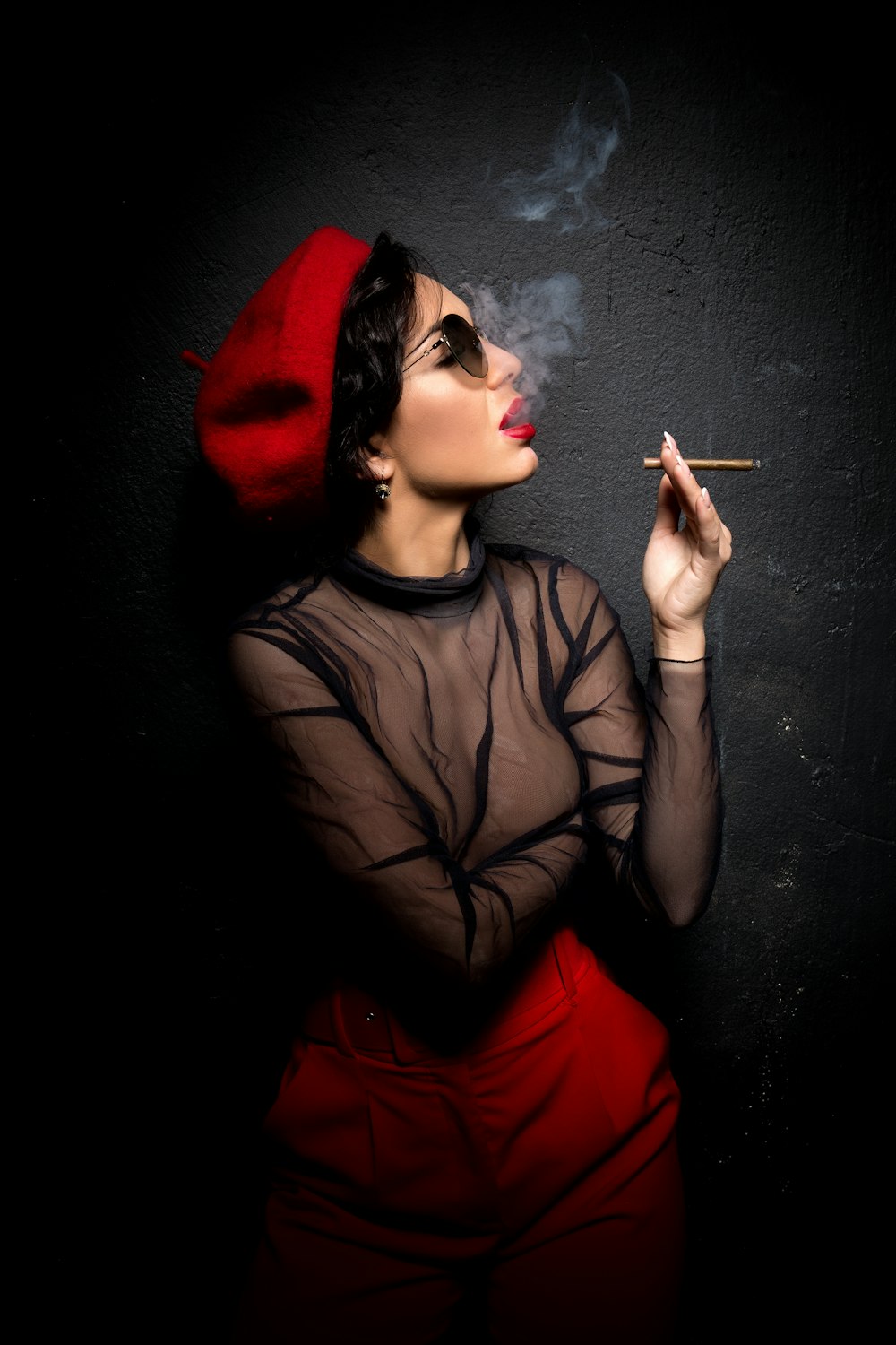woman in black tank top smoking cigarette