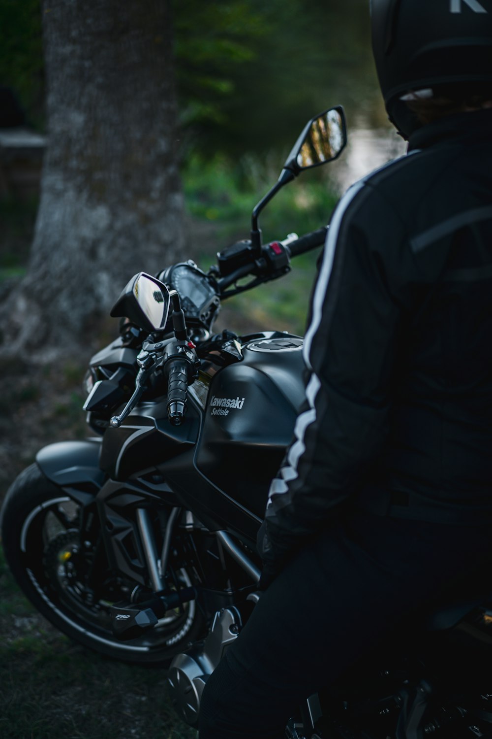 man in black jacket riding black motorcycle