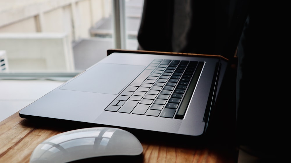 macbook pro on brown wooden table