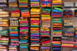 Shelves filled with neatly folded clothes showcasing a variety of textures and colors.