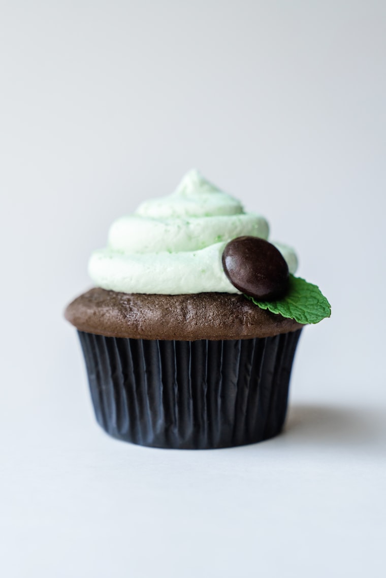 Mug cake with cream frosting served on a white plate