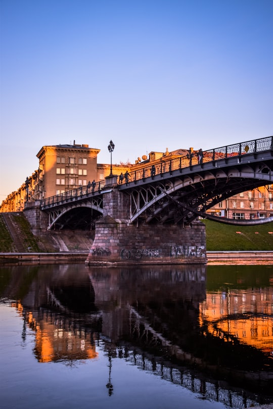 brown concrete bridge over river during daytime in Vilnius Lithuania
