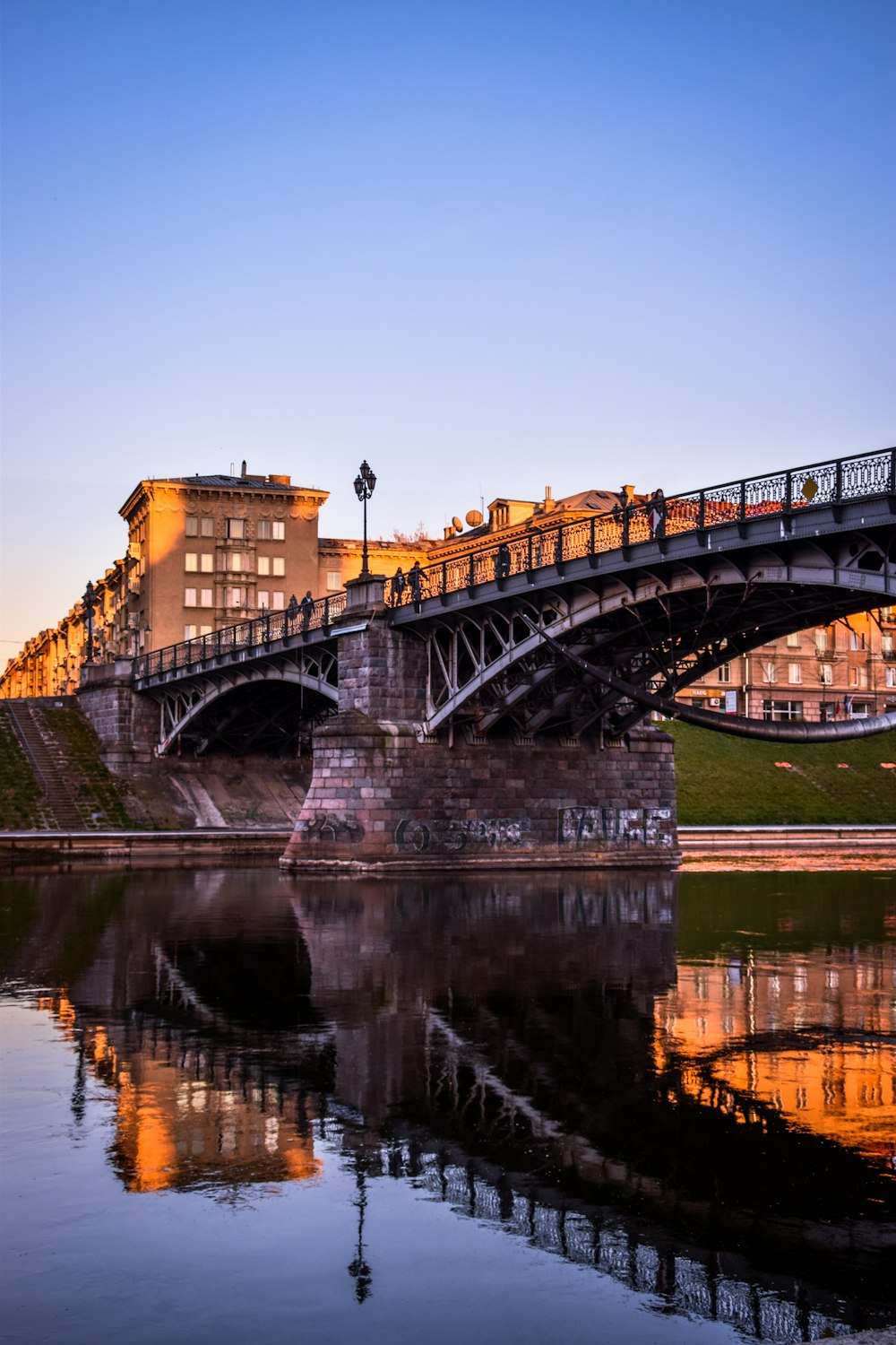 brown concrete bridge over river during daytime