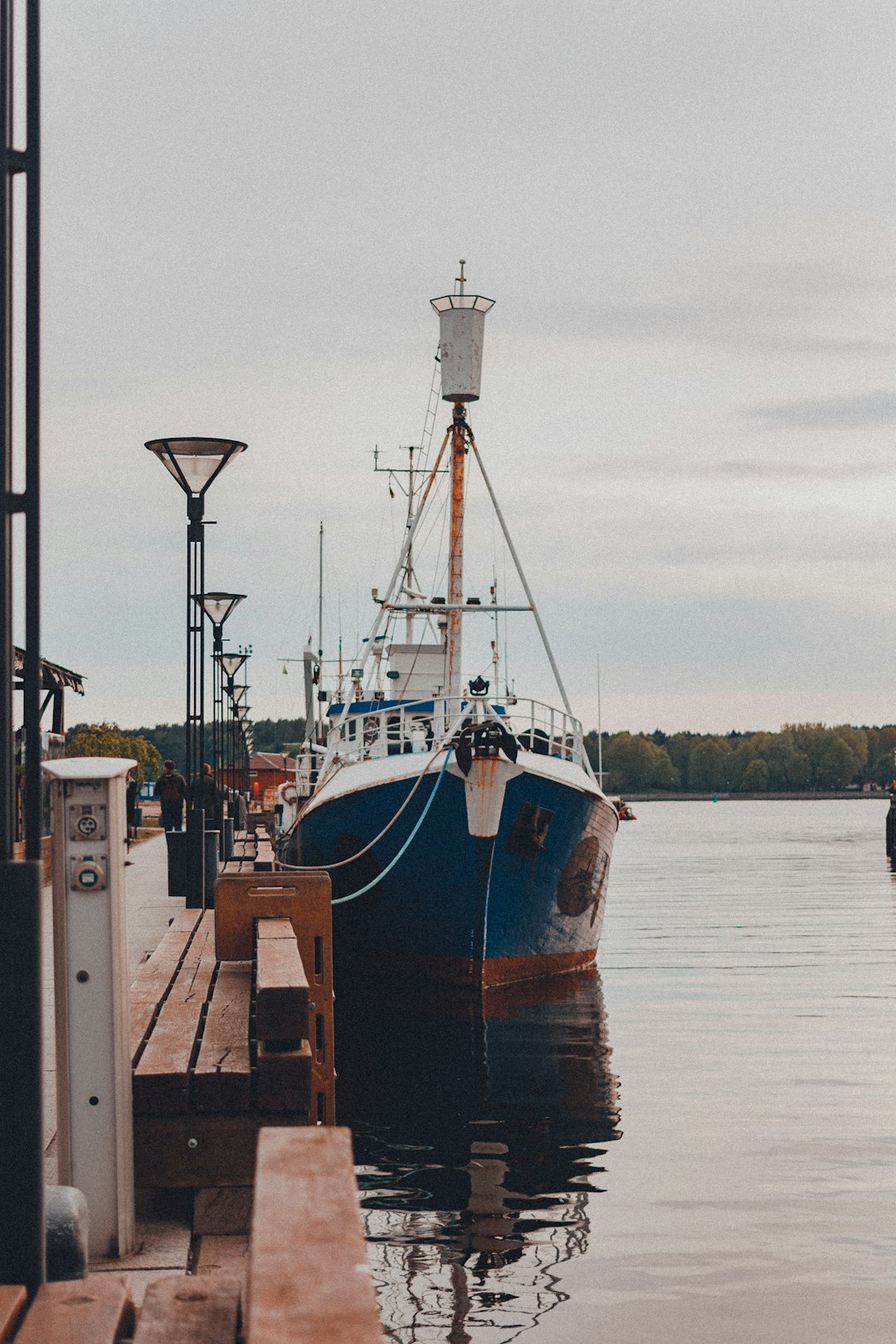 brown and white boat on dock during daytime