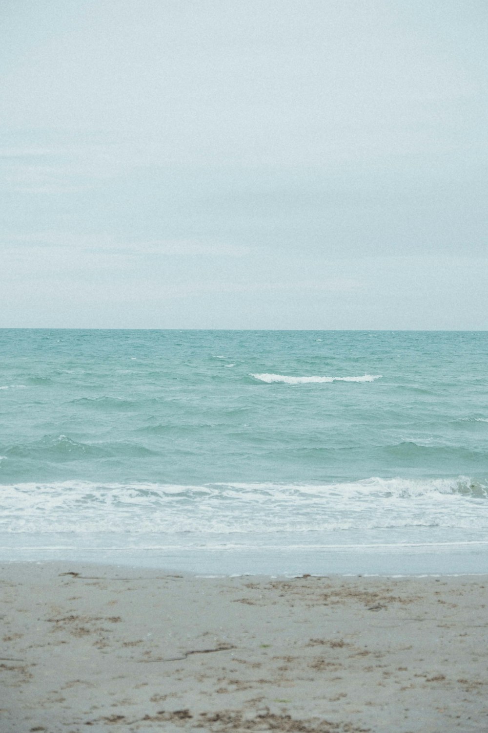 ocean waves crashing on shore during daytime