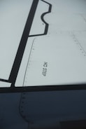 A technician conducting an inspection on an aircraft wing.