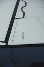 A technician conducting an inspection on an aircraft wing.