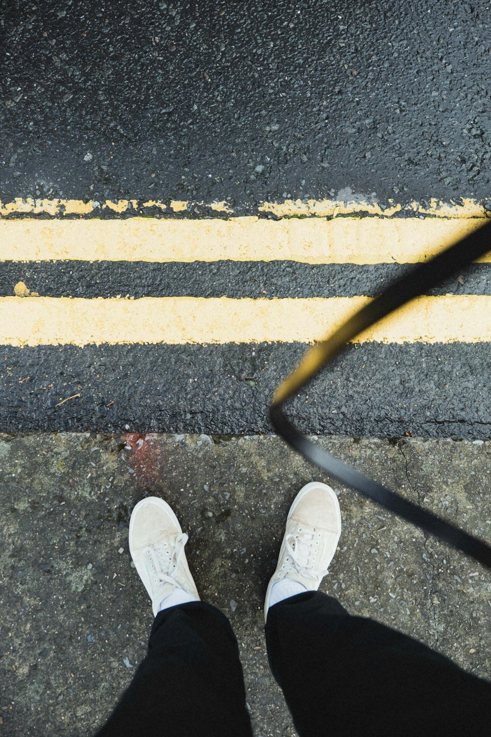 detail kapitel sig selv person in white sneakers standing on gray concrete pavement photo – Free  Beige Image on Unsplash