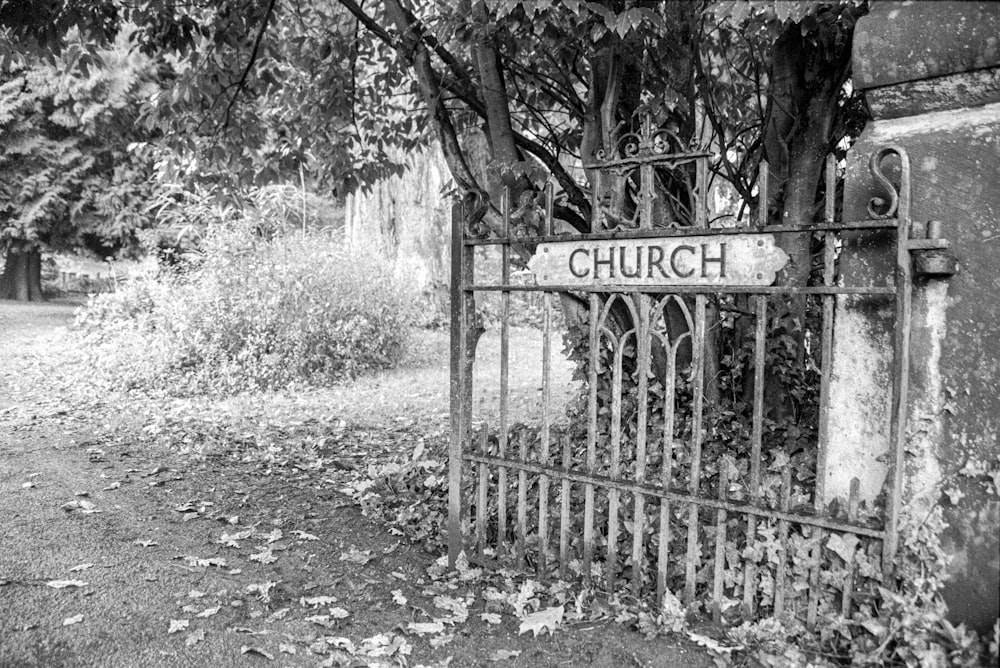 grayscale photo of wooden fence with no smoking sign