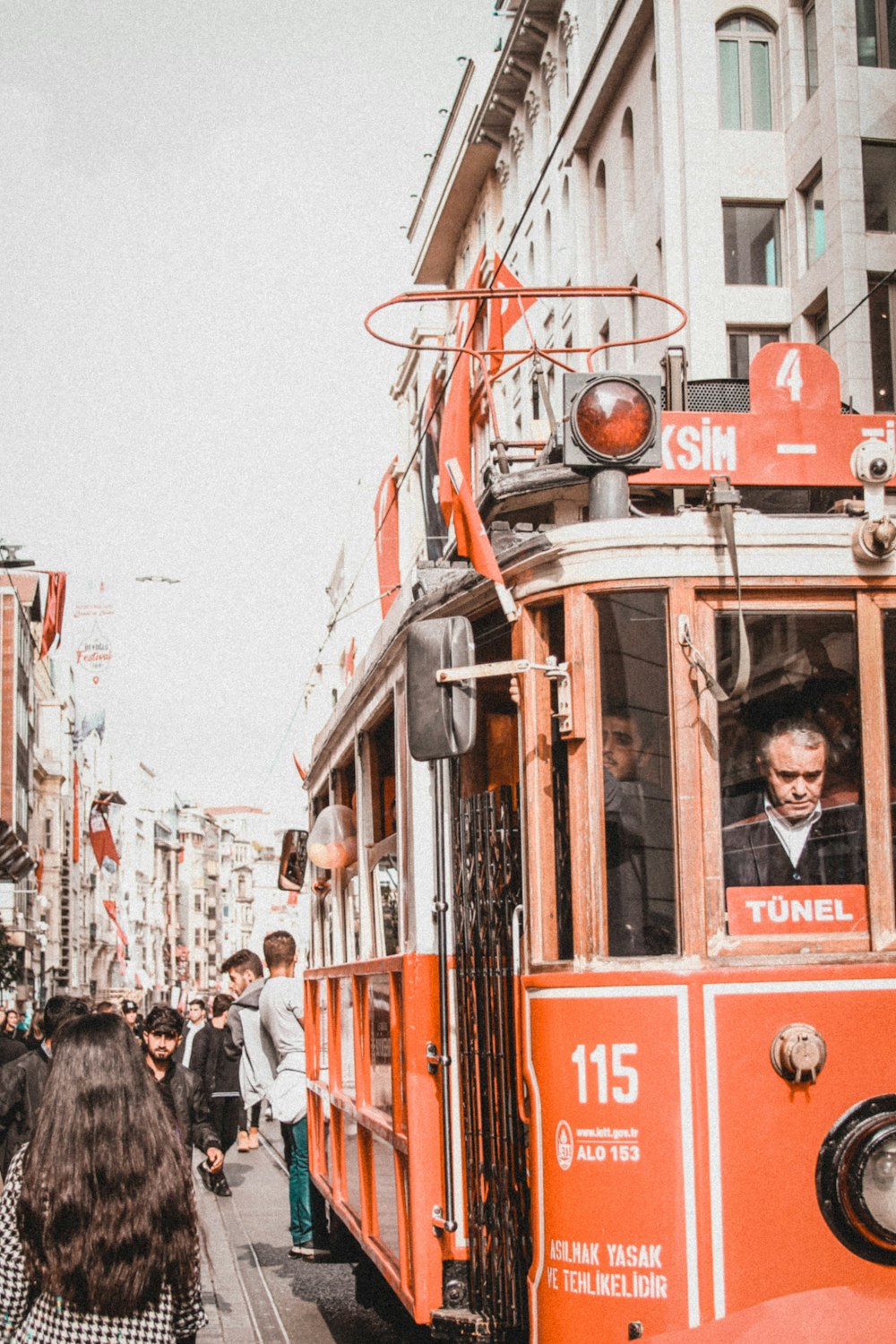 red and white tram on the street during daytime