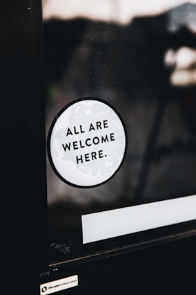 a sticker that says all are welcome here