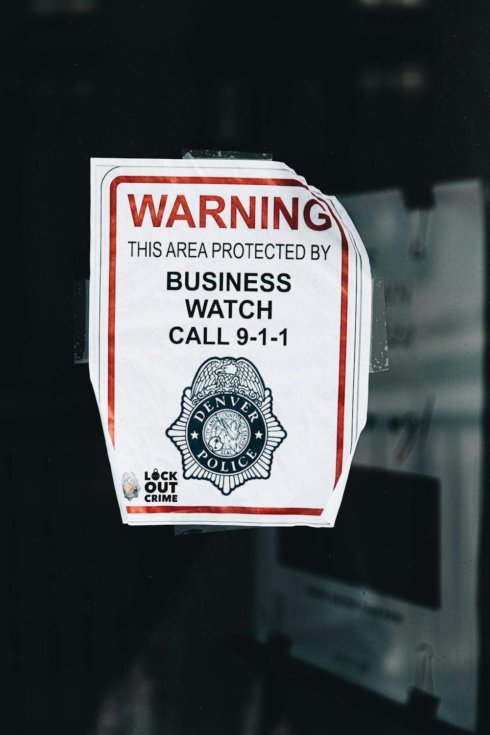 a business watch sign hanging on a door
