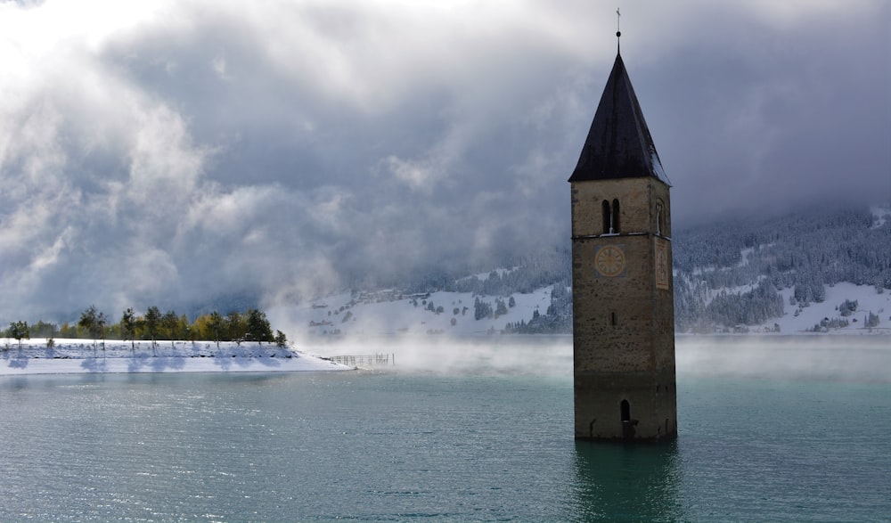 brown concrete building near sea under white clouds during daytime