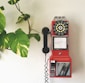 red and black telephone on white wall