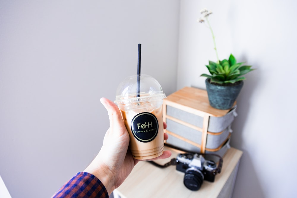 person holding dunkin donuts cup