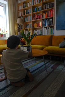 woman in white shirt sitting on yellow couch