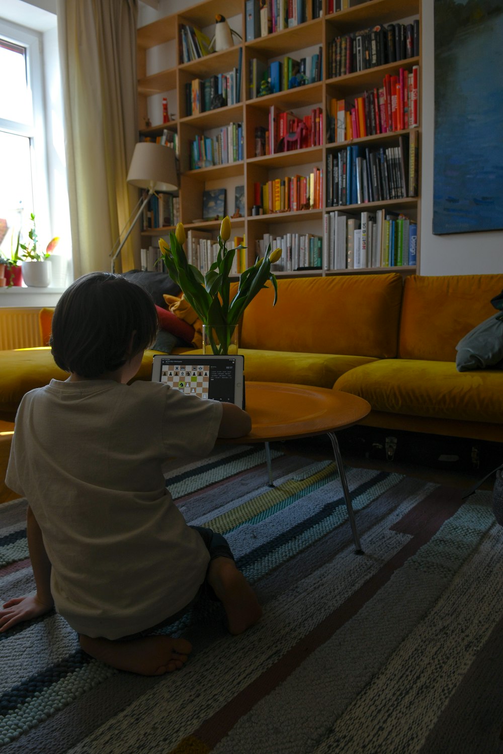 woman in white shirt sitting on yellow couch