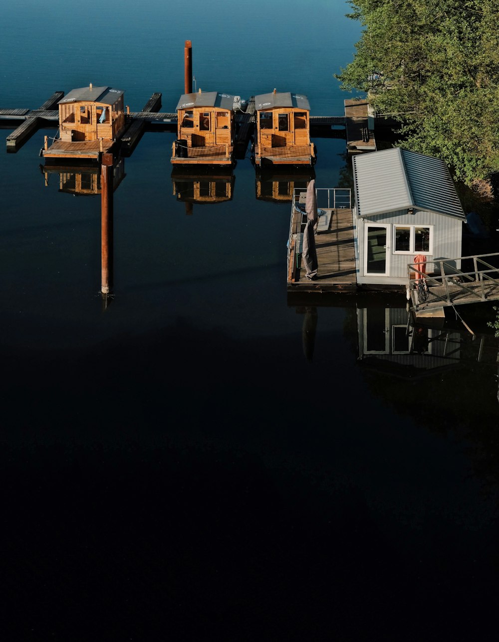 white and brown houses near body of water during night time