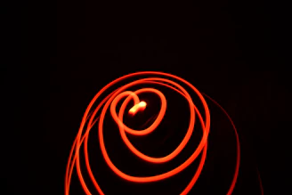 An abstract pattern of colorful light trails captured with long exposure photography.