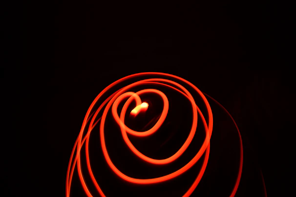 An abstract pattern of colorful light trails captured with long exposure photography.